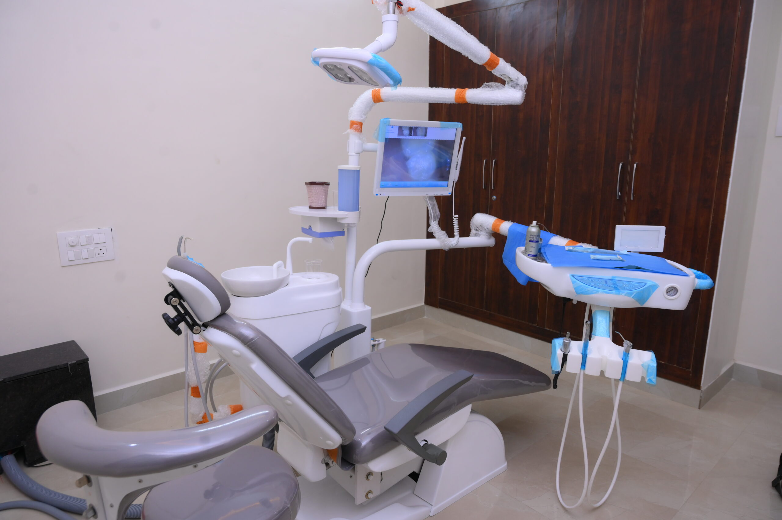 Modern dental treatment chair with digital monitoring at SJ Apex Dental Kondapur